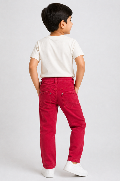 Red denim jeans back view with belt loops and button closure; child wearing sneakers