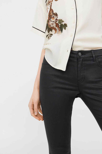 MANGO women's black jeans close-up: waistband button, belt loops, pocket seam