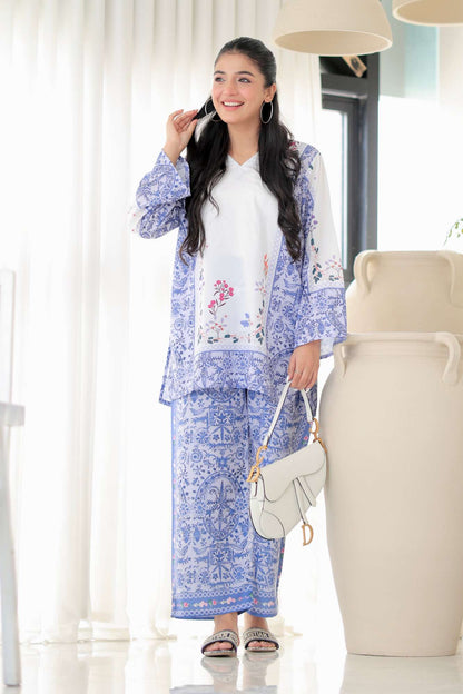 Womenâ€™s blue floral printed kurta set with white inner top, matching pants, crossbody bag
