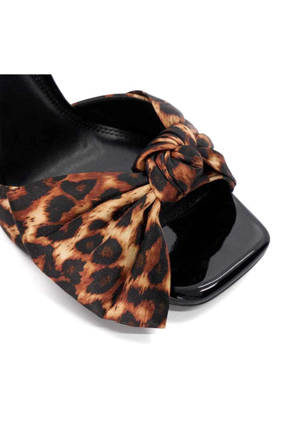 Close-up of leopard print knotted bow detail on heeled sandal