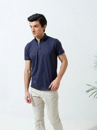 Navy polo shirt with short sleeves and button placket, side view