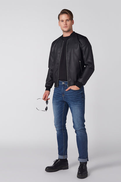 Men's black zip-up jacket with stand collar, ribbed cuffs, and blue jeans