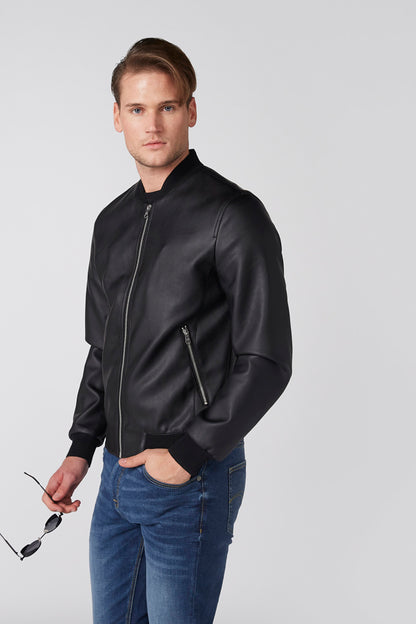 Men's black zip-up jacket, side view with zip pocket detail over blue jeans