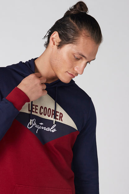 Colorblock hoodie with front logo patch and drawstring hood; close-up