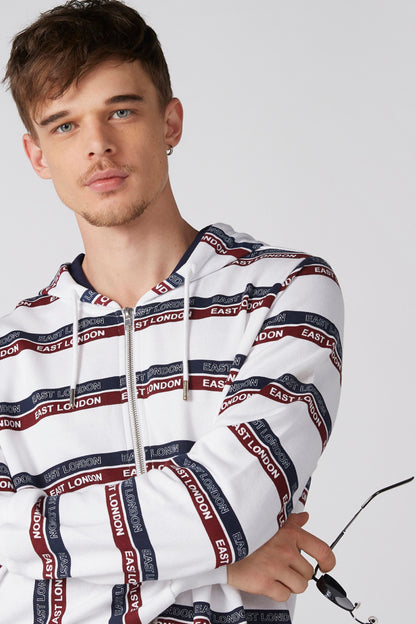 White zip-up hoodie with East London stripe print, front close-up detail.