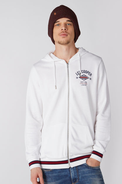 White zip-up hoodie with hood, drawstring, and red/blue striped cuffs and hem