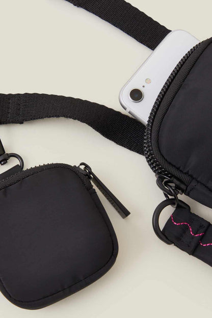 Accessorize black zip crossbody bag with two front pockets and zipper pull detail