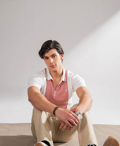Men's fitted polo shirt with light pink body, white sleeves, and short button placket