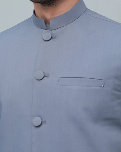 Light blue stand-collar waistcoat with round buttons and chest pocket