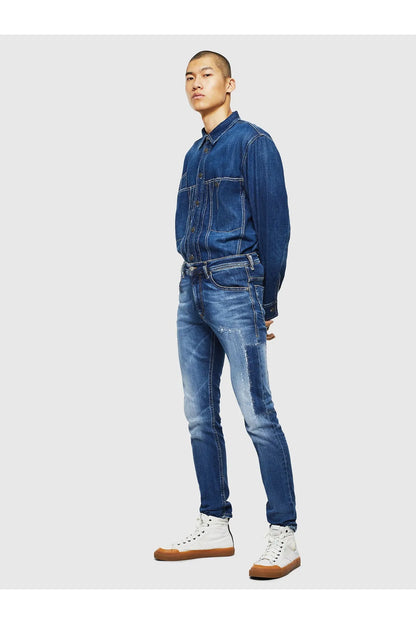 Blue denim jeans on model, full-body side profile with slim leg and belt loops