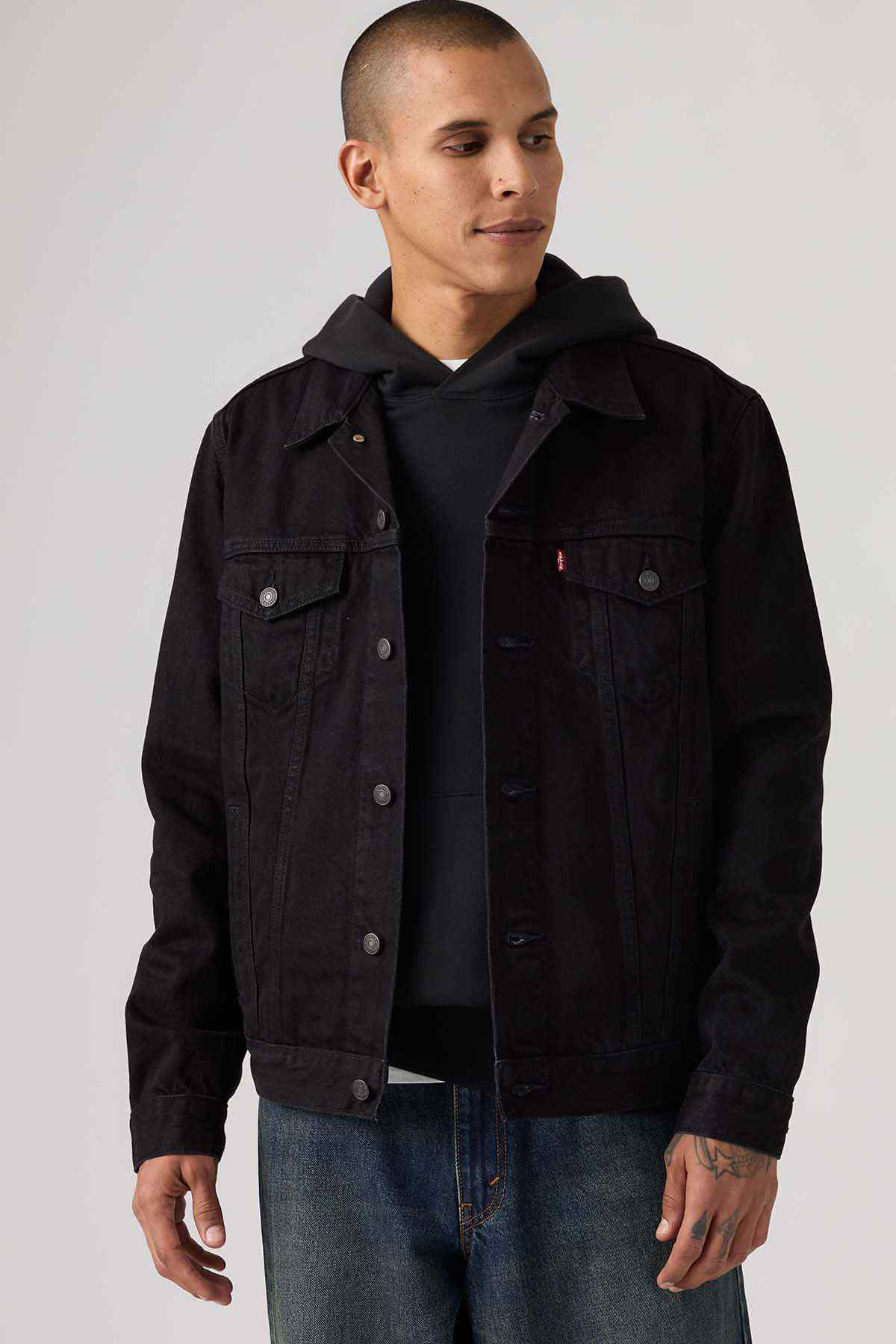 Levi's black denim jacket with button front and flap chest pockets, hood peeking