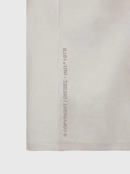 Off-white T-shirt fabric closeup with vertical 'DIESEL' copyright text