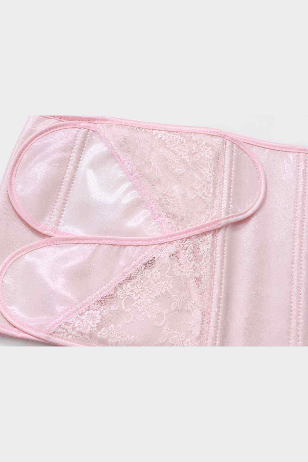Pink bib apron close-up with sheer lace insert and scalloped edge trim