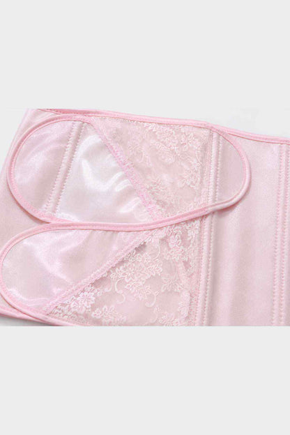 Pink bib apron close-up with sheer lace insert and scalloped edge trim