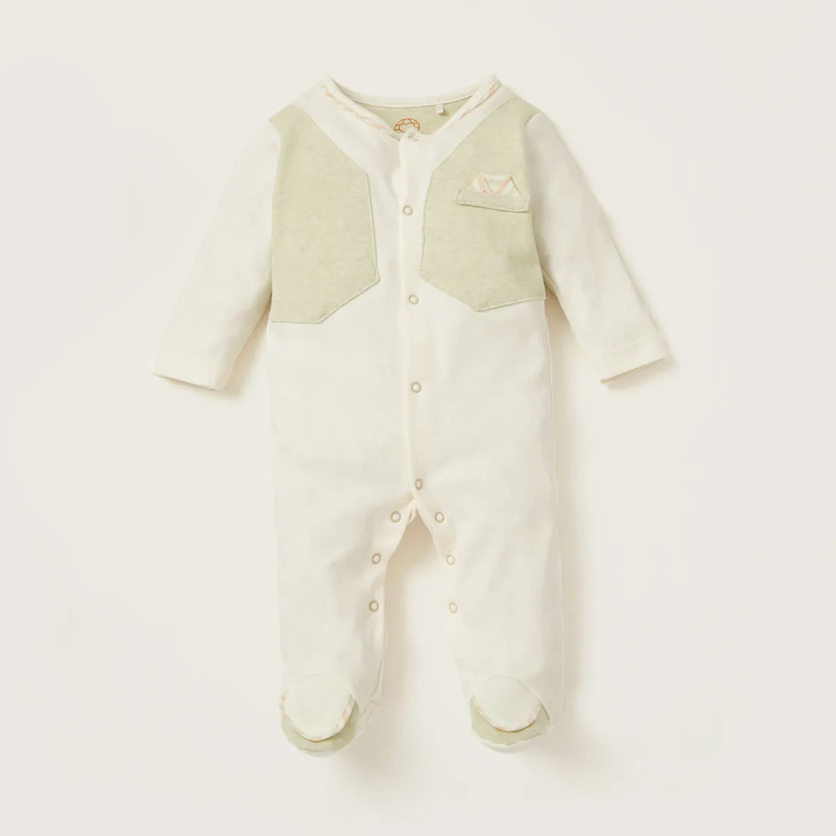 Baby footed onesie romper in off-white with light green chest panel and snap buttons