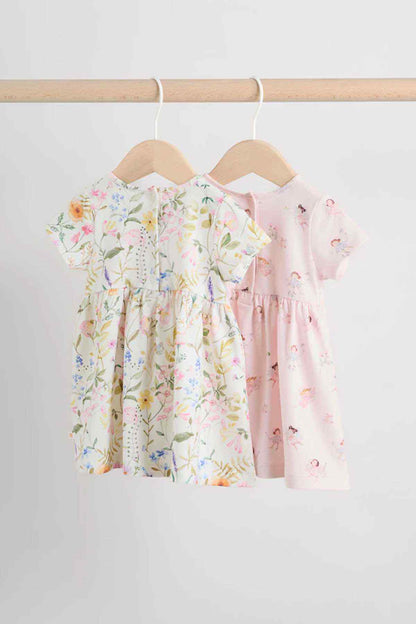 Kids floral dress set: cream and pink short-sleeve dresses on hangers