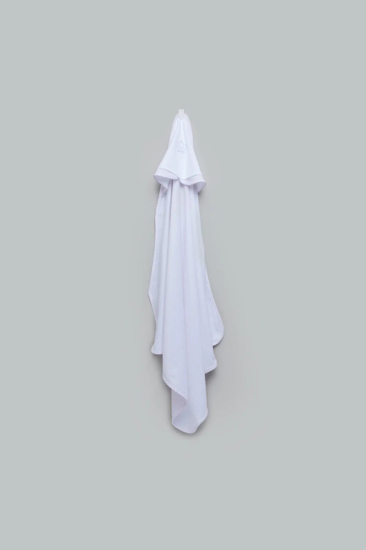 White hooded baby towel with draped corners and soft fabric