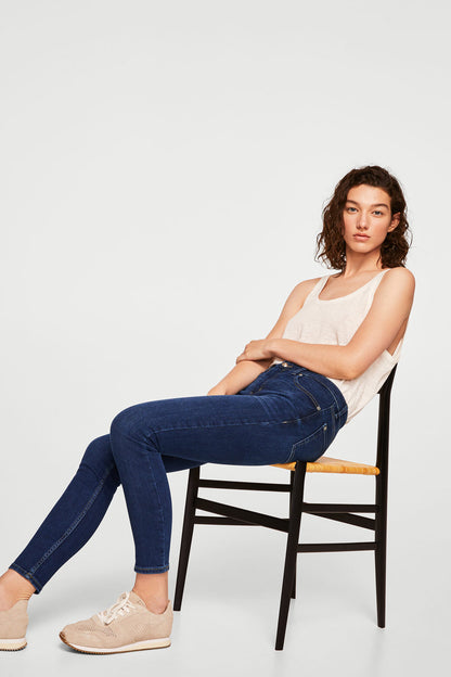 Dark blue slim-fit denim jeans with stitched seams, full length