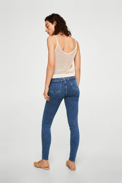 Medium blue skinny jeans with slim leg, button fly, and back welt pockets