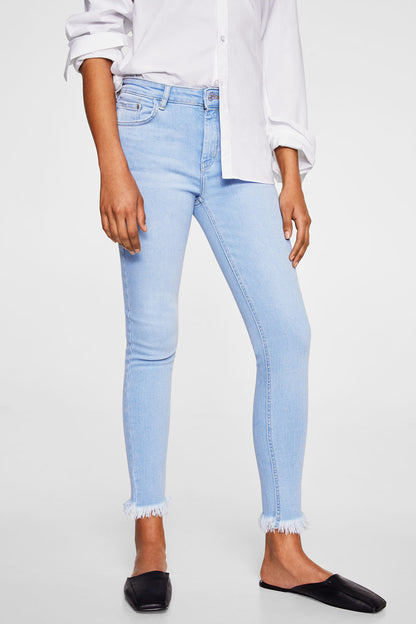 Light blue skinny jeans with frayed ankle cuffs, button-and-zip fly