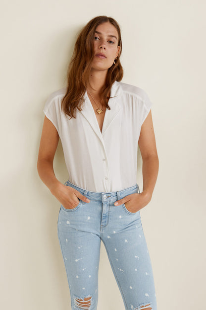 Light blue skinny jeans with white speckle and distressed rips at knees