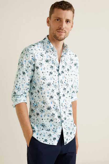 Men's light blue floral button-up shirt with rolled sleeves and open collar