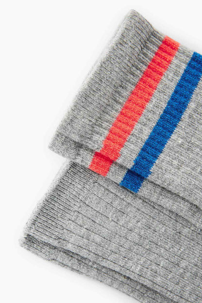 Grey crew sock cuff detail with red and blue stripe band