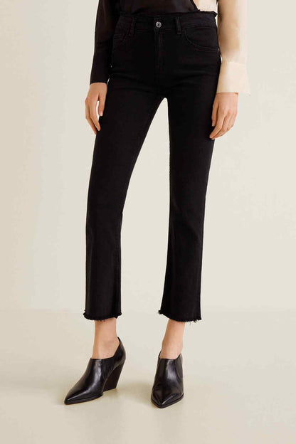Black denim jeans with cuffed cropped hem and button-and-zip closure