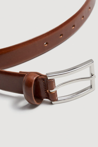 Brown leather belt with silver buckle and loop keeper close-up