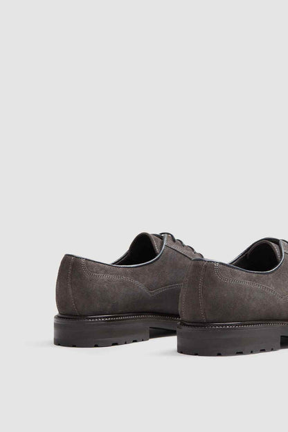Grey suede lace-up shoes with black sole and stitched low-profile edge