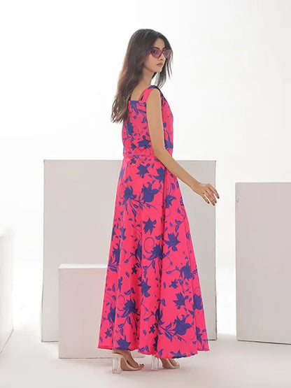 Pink floral sleeveless maxi dress with flared skirt and dark blue print, side view
