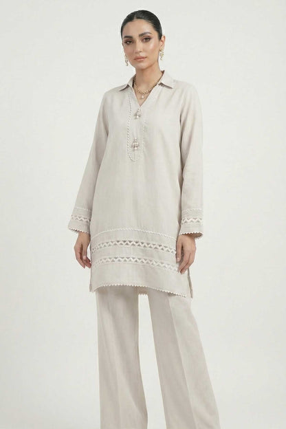 Light grey tunic with embroidered vertical placket and lace hem, paired with trousers.
