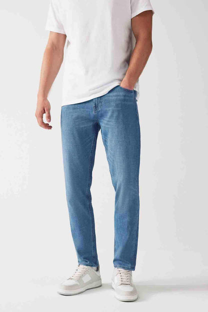 Light blue denim jeans with cuffed hem, visible seams, and front pocket detailing