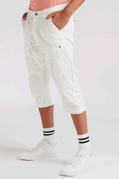 White knee-length cargo shorts with flap pockets and side button closure