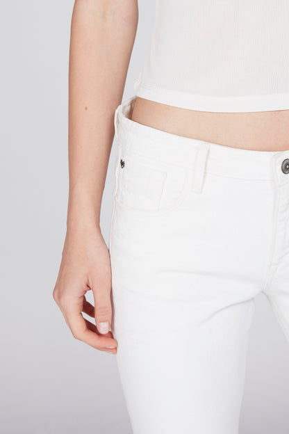 White denim jeans close-up: front button, belt loops, and side pocket.