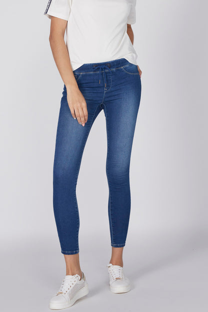 Blue slim jeans with belt loops, ankle-length cuffs, and whisker seams