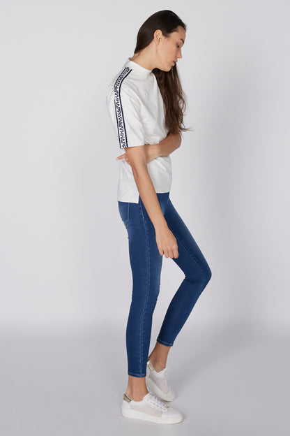 Blue skinny jeans with cuffed hems and zip fly