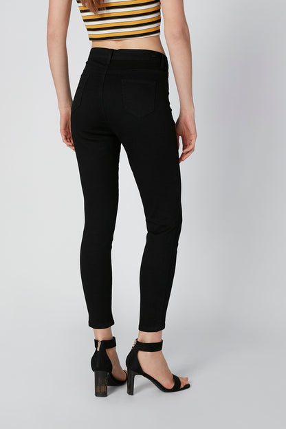 Black skinny ankle pants with back pockets and cuffed hem; striped top