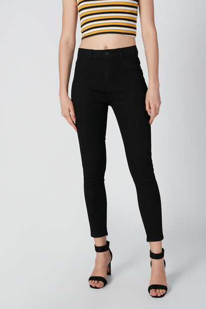 Black ankle pants with front button and zipper; bare midriff striped top