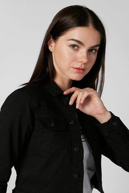 Black denim jacket close-up with flap collar and buttoned chest pockets