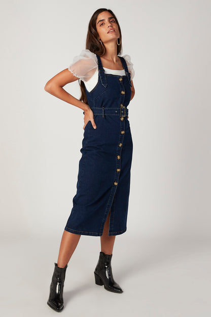Blue denim pinafore midi dress with adjustable straps and center front slit