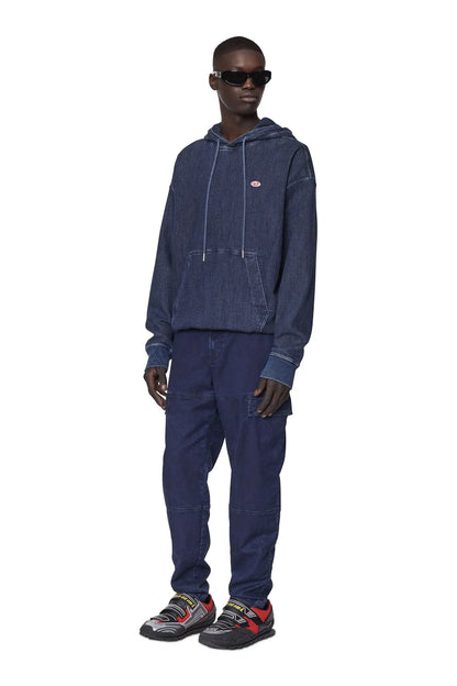 Dark blue denim cargo pants on model, full length with patch pockets and cuffed hem