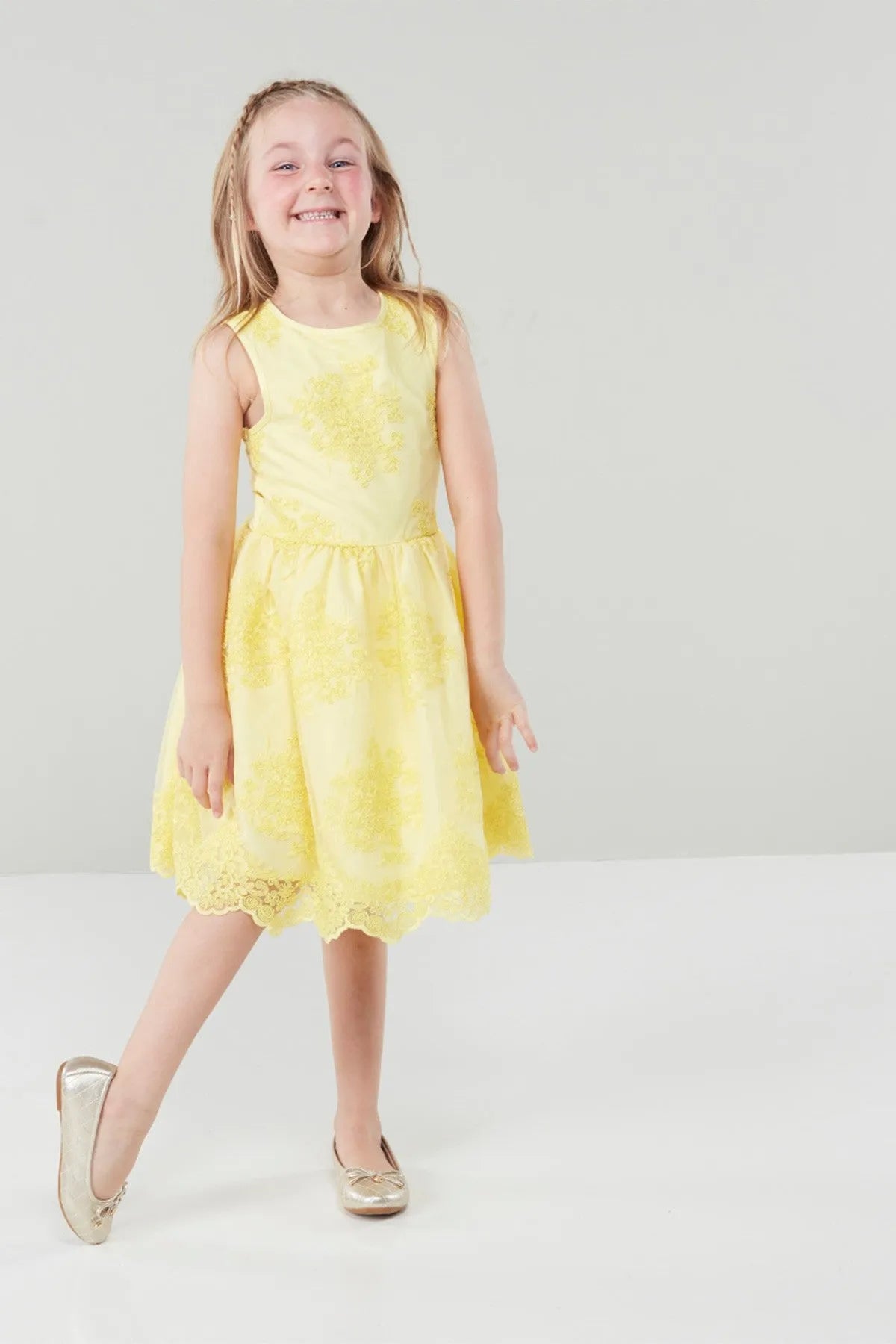Yellow sleeveless toddler dress with floral pattern, flared hem and round neckline