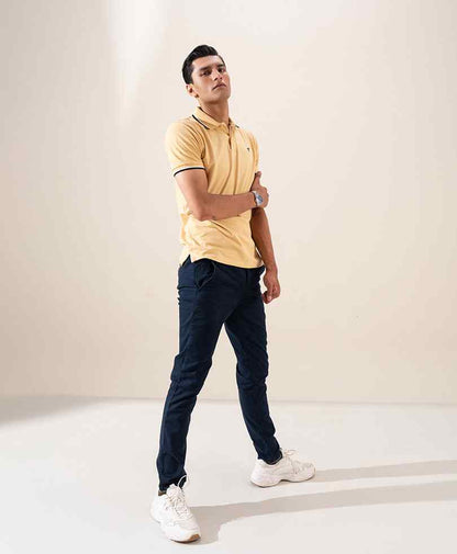 Yellow fitted polo shirt with dark collar trim and short sleeves