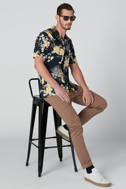 Men's navy short-sleeve button shirt with yellow floral and fireworks pattern