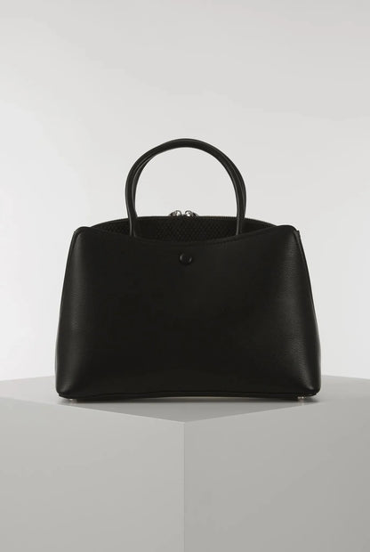 Black structured handbag with top handles and front button closure, gold hardware