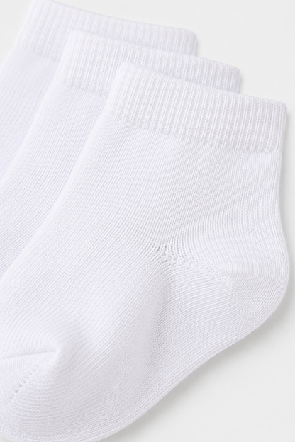 White ribbed-knit baby sock with cuff and stitched toe