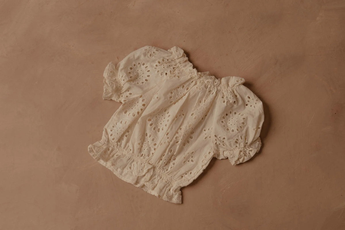 Cream eyelet puff-sleeve blouse with gathered neckline and elastic seams