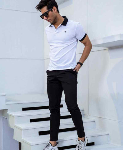 White fitted polo shirt with black collar and short sleeves, small chest logo