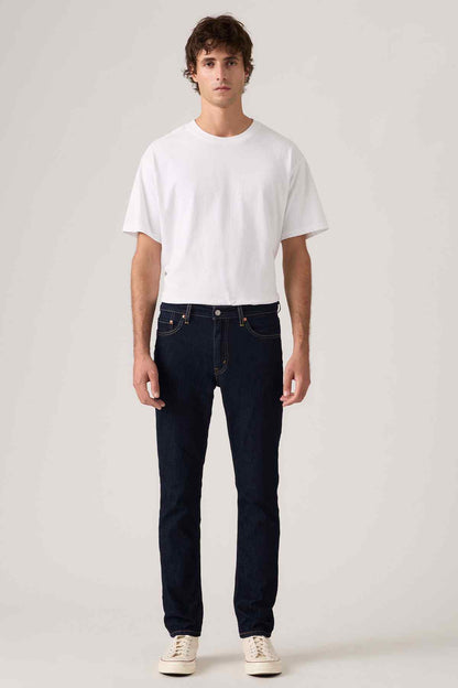 Dark blue denim jeans with straight fit, button fly, and belt loops, front view